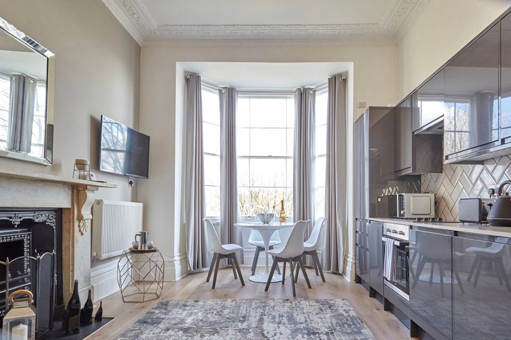 Property photo 3 of 6 A Modern And Clean Kitchen With A Dining Area Feat...