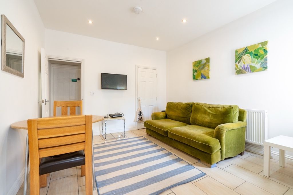 Property photo 1 of 10 Bright And Spacious Living Room Featuring A Comfor...