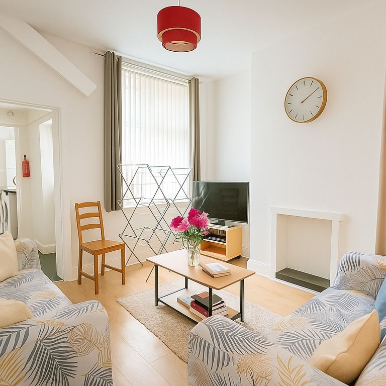 Property photo 1 of 6 A Bright And Inviting Living Room Featuring Comfor...