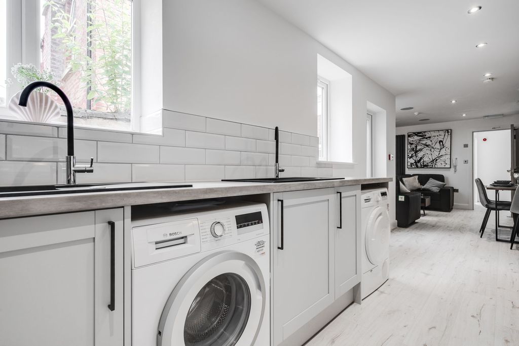 Property photo 2 of 4 Modern And Bright Kitchen With Clean, White Cabine...
