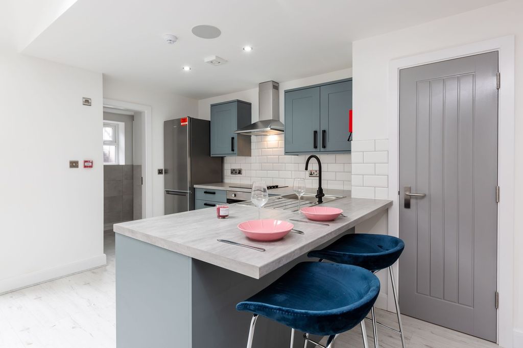 Property photo 3 of 5 Modern, Stylish Kitchen Featuring Blue Cabinetry, ...