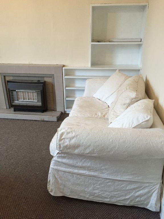 Property photo 3 of 9 A Cozy Living Room Featuring A Comfortable White S...