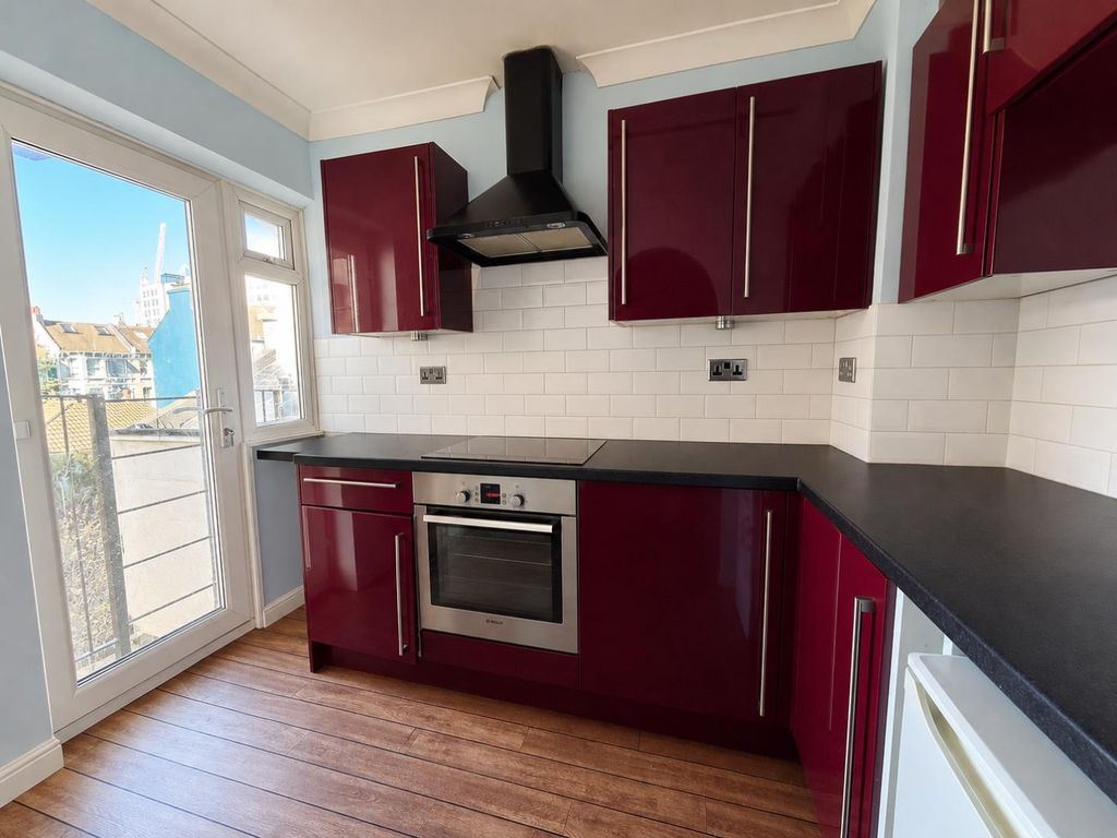 Property photo 2 of 7 Bright Burgundy Kitchen With City Views.Png