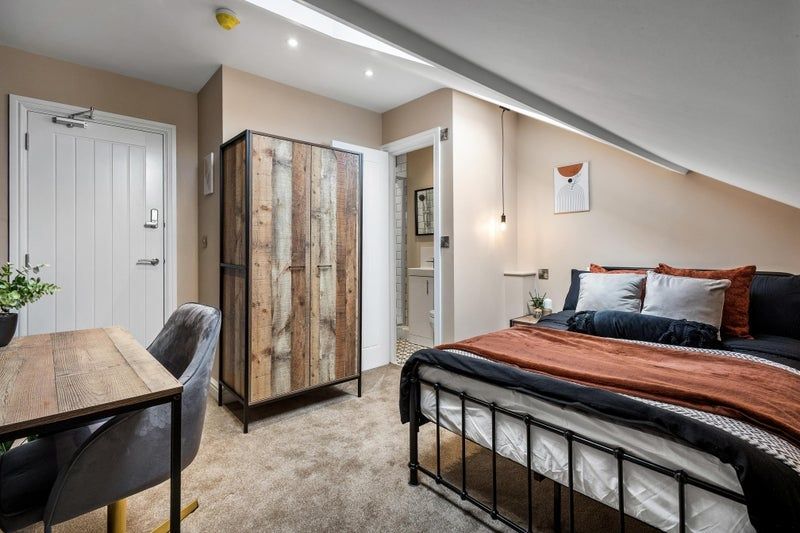 Property photo 2 of 17 A Stylish And Cozy Master Bedroom Featuring A Comf...