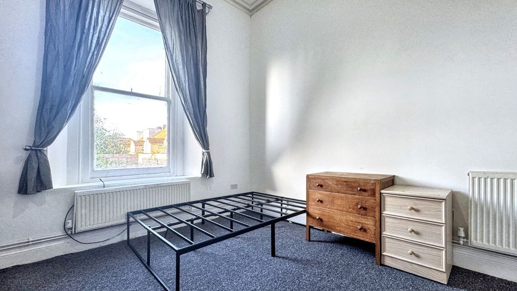 Property photo 1 of 4 Bright, Simply Furnished Bedroom With A Large Wind...