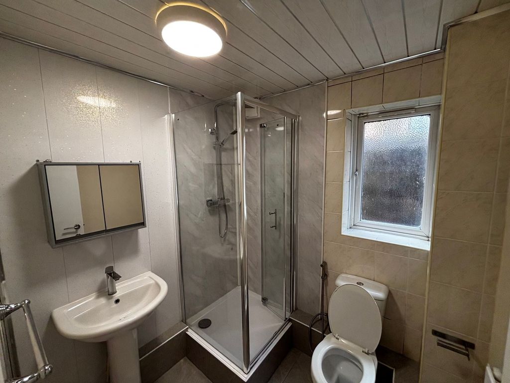 Property photo 3 of 7 A Clean And Functional Bathroom With A Shower Encl...