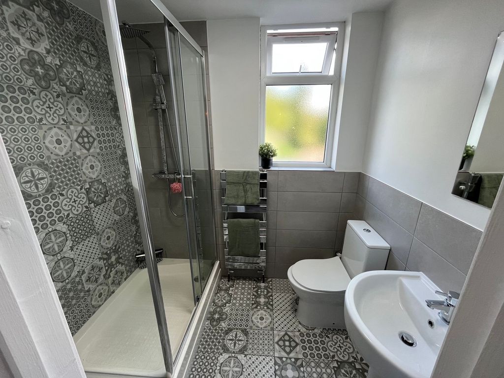 Property photo 1 of 7 Bright And Modern Bathroom Featuring Patterned Til...