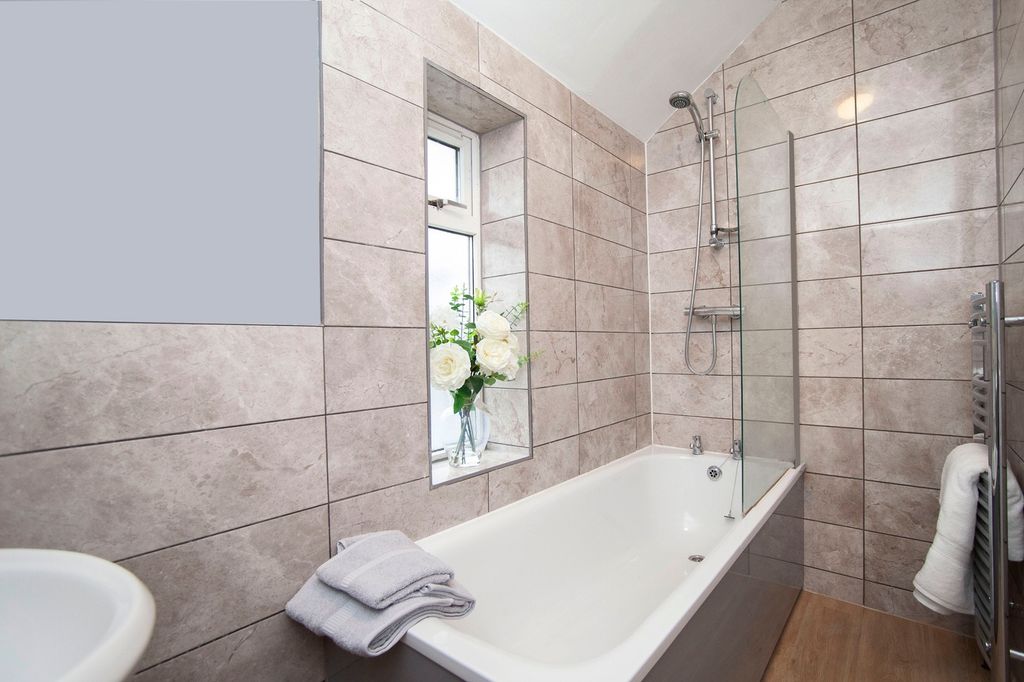 Property photo 2 of 26 A Clean And Bright Bathroom Featuring A Bath, Mode...