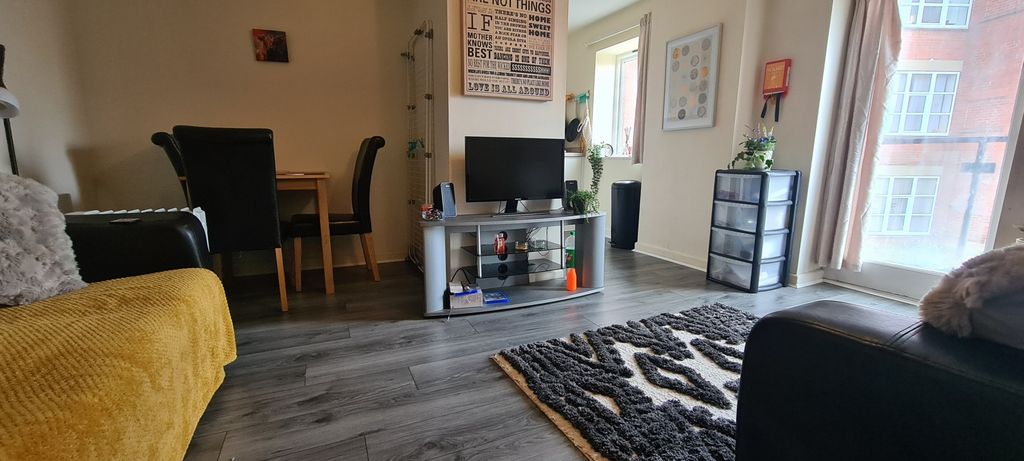 Property photo 1 of 8 A Spacious And Inviting Living Room Filled With Na...