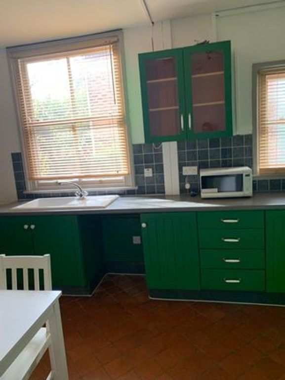 Property photo 3 of 7 A Bright And Tidy Kitchenette Featuring Stylish Gr...