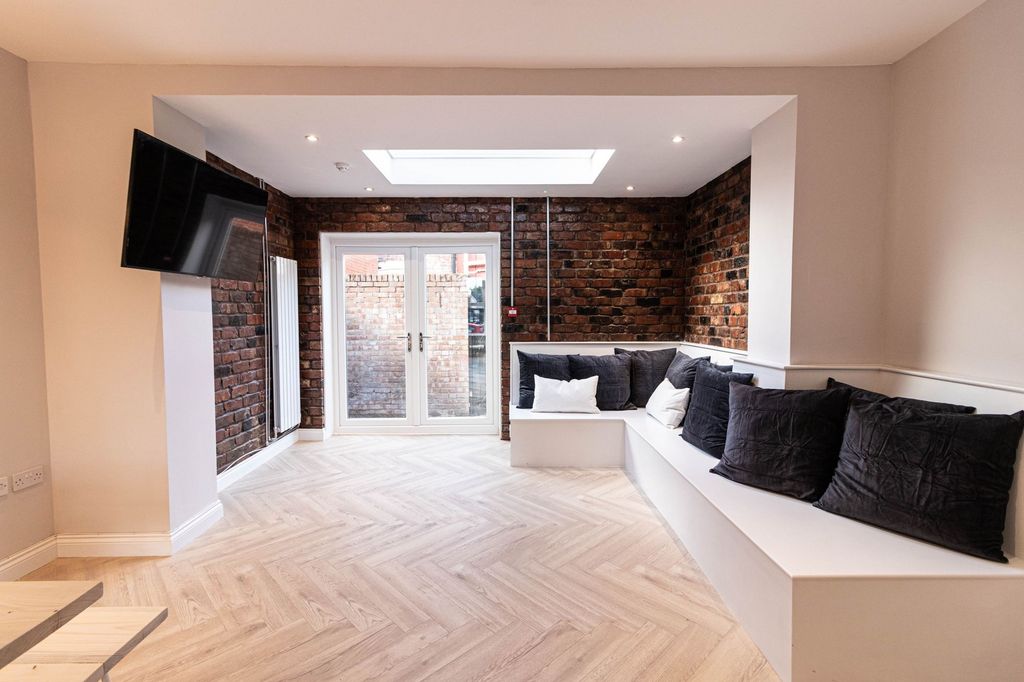 Property photo 1 of 7 Modern Living Room With A Stylish Exposed Brick Wa...