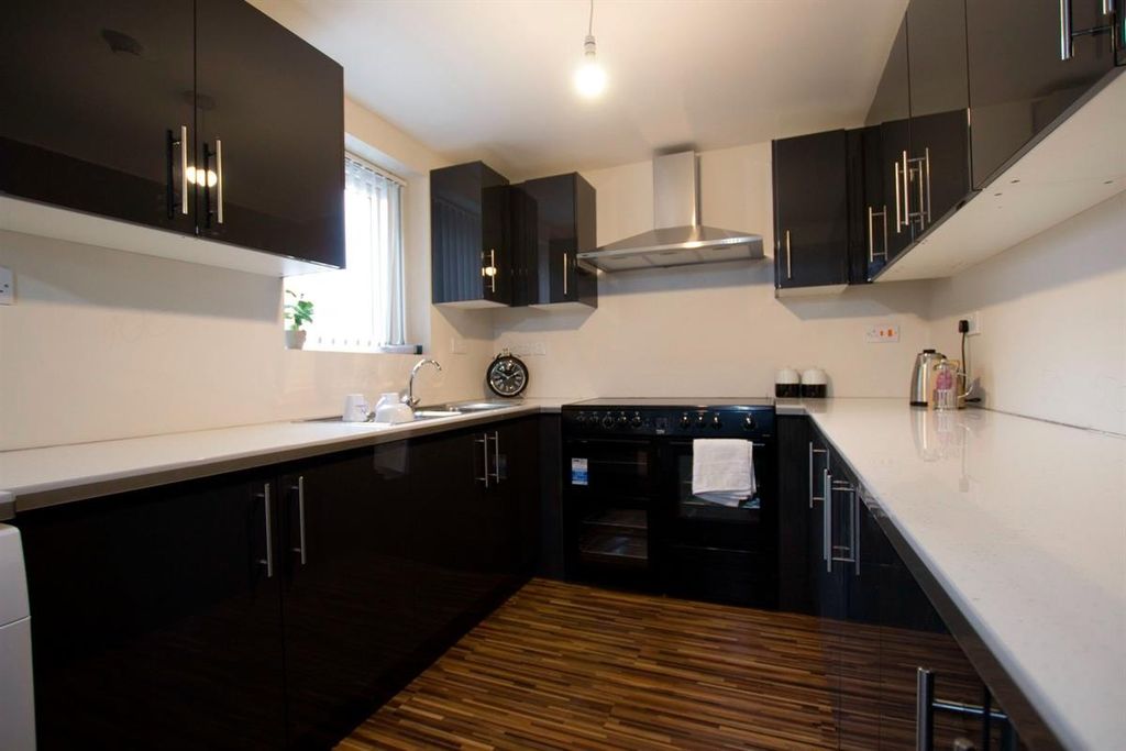 Property photo 1 of 13 Modern Kitchen Featuring Sleek Black Cabinetry And...