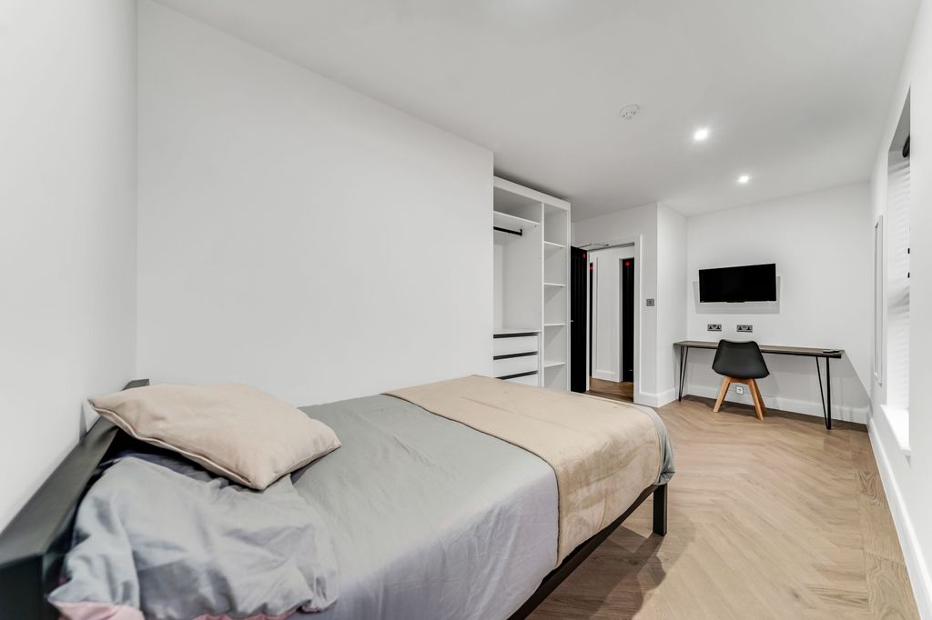 Property photo 2 of 5 A Bright And Modern Living Room Featuring A Clean,...