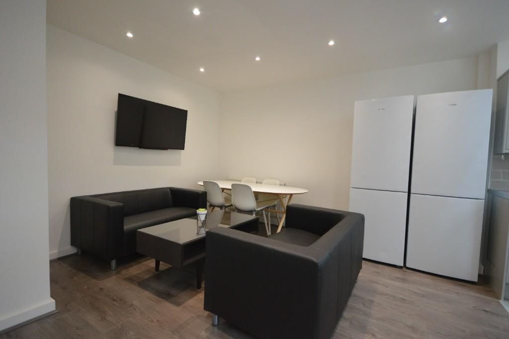 Property photo 2 of 12 A Modern Living Room Featuring Sleek Black Sofas A...