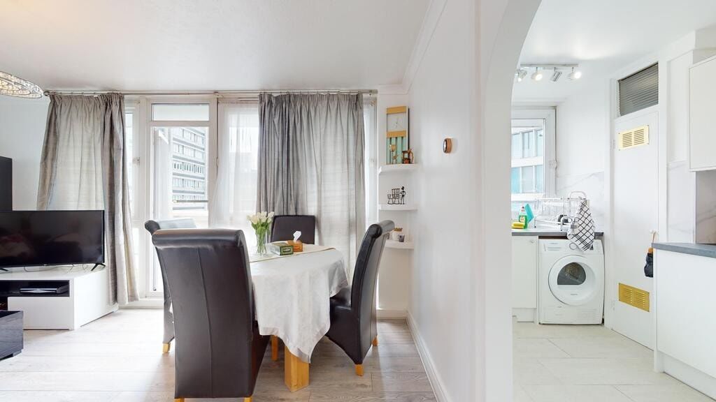 Property photo 3 of 19 Bright And Spacious Living Room Featuring Large Wi...