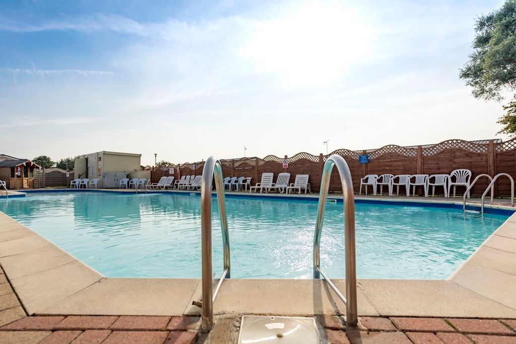 Property photo 2 of 5 Outdoor Swimming Pool At Winchelsea Sands Holiday Park With Sun Loungers And Seating