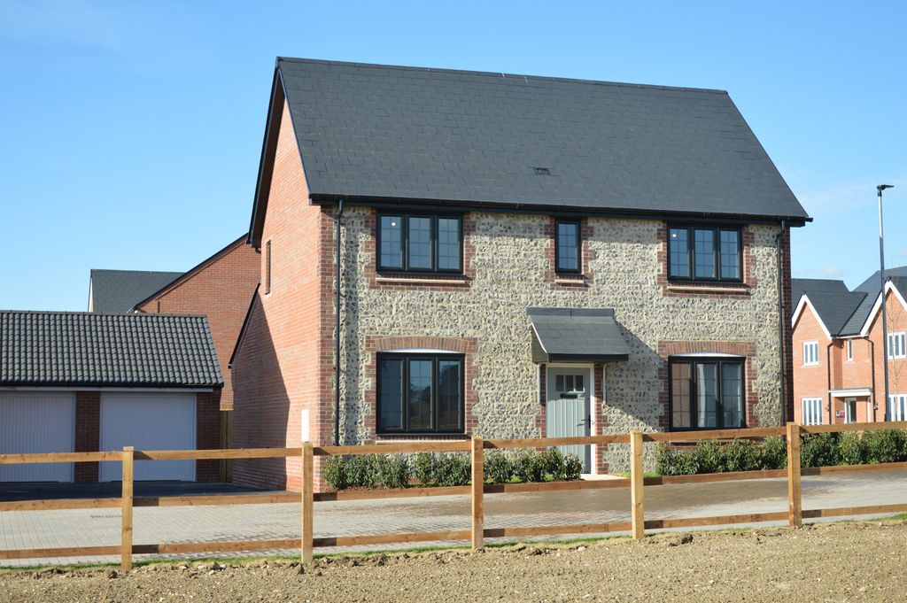 Property photo 1 of 10 A Modern Stone And Brick House With A Dark Roof Stands Behind A Wooden Fence In The Foreground
