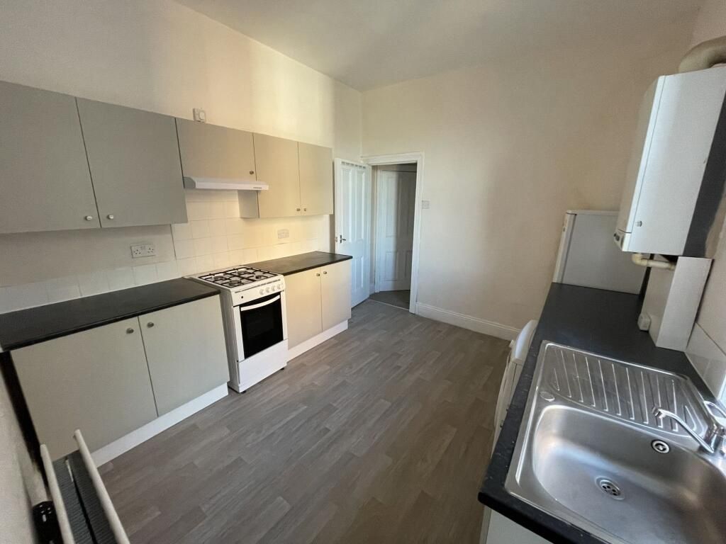 Property photo 1 of 5 Bright Galley-Style Kitchen With Modern Laminate F...