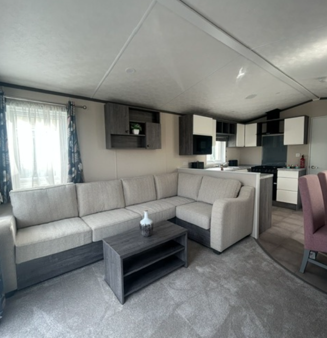 Property photo 1 of 3 Spacious Living Area With L Shaped Sofa And Open Plan Kitchen In The Pemberton Avon