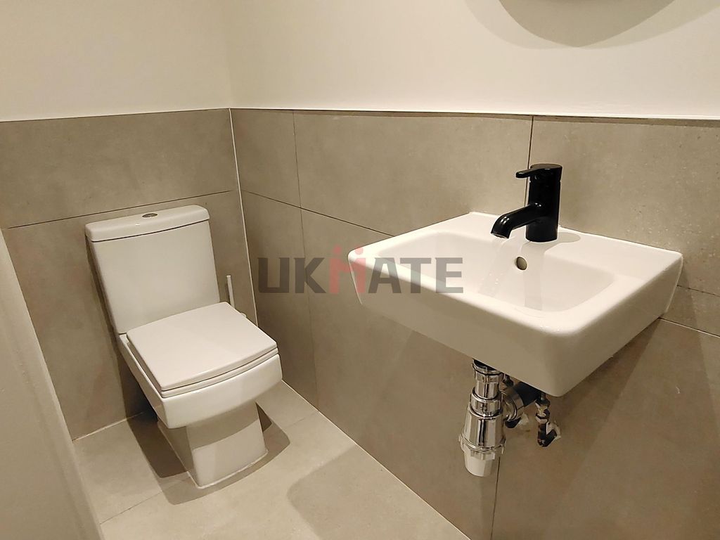 Property photo 1 of 10 Modern Bathroom Featuring A Compact Sink With A Sl...