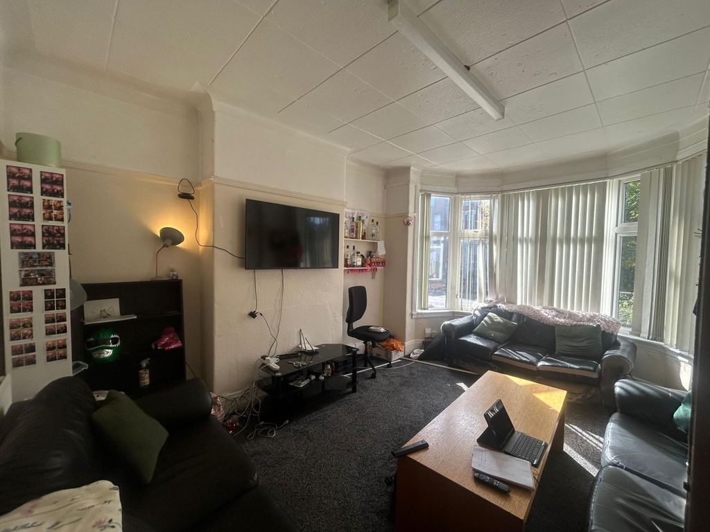 Property photo 3 of 23 A Spacious And Inviting Living Room With Large Win...
