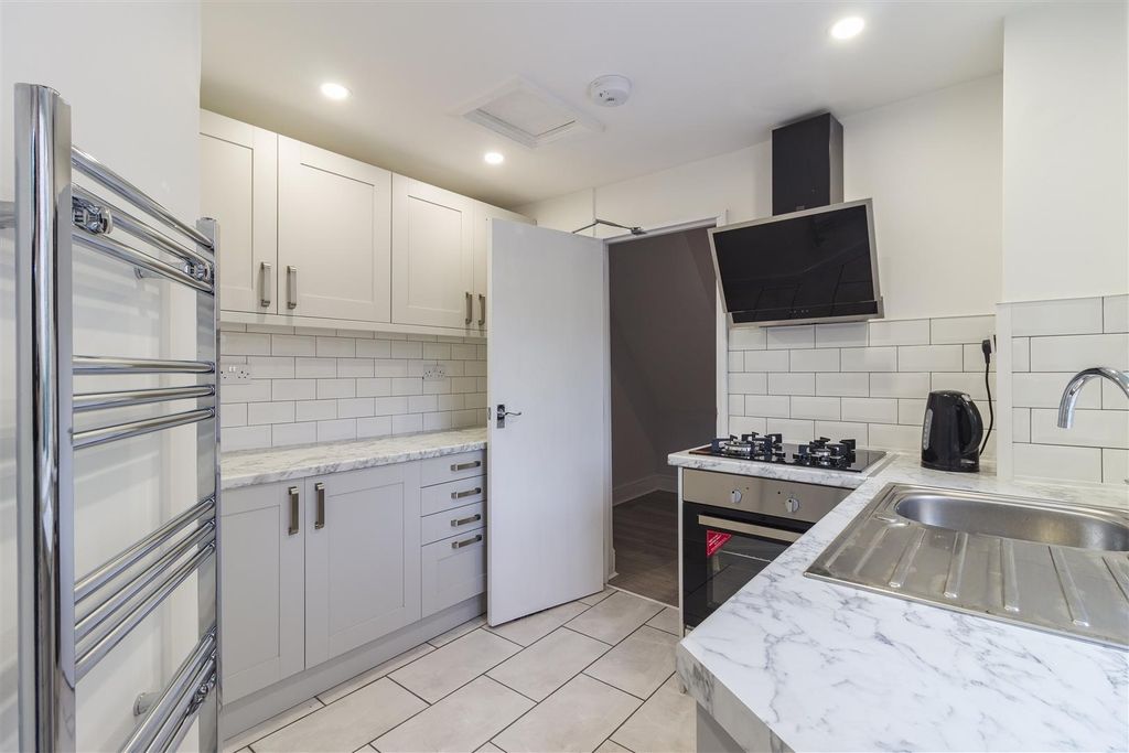 Property photo 2 of 9 Modern Kitchen With Sleek White Cabinets....