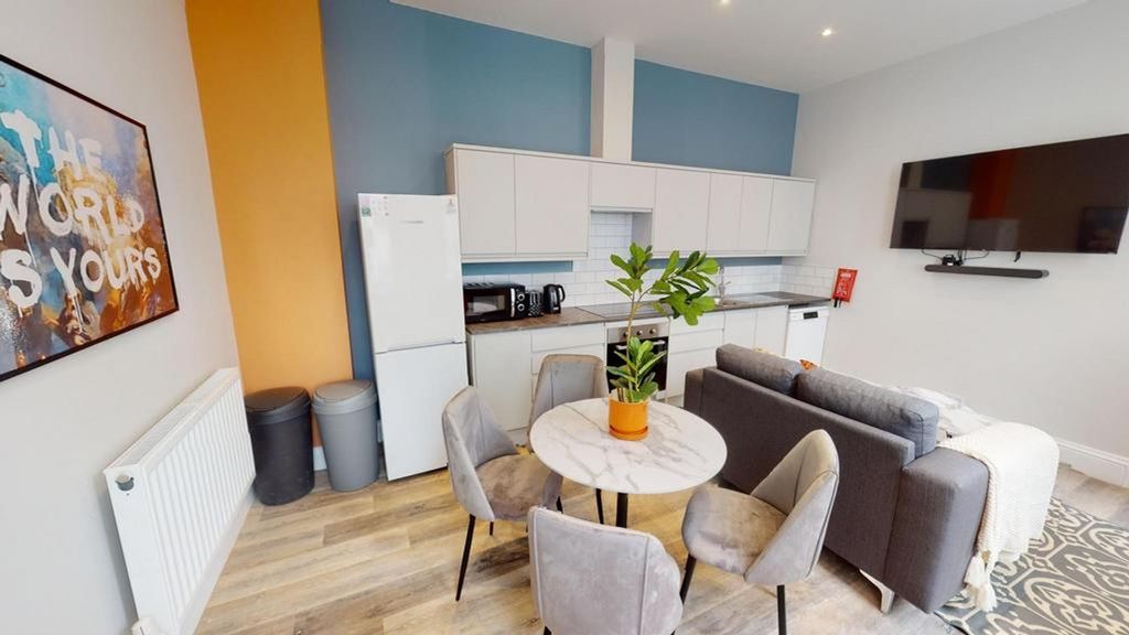 Property photo 2 of 9 A Bright And Modern Living Room Featuring A Cozy S...