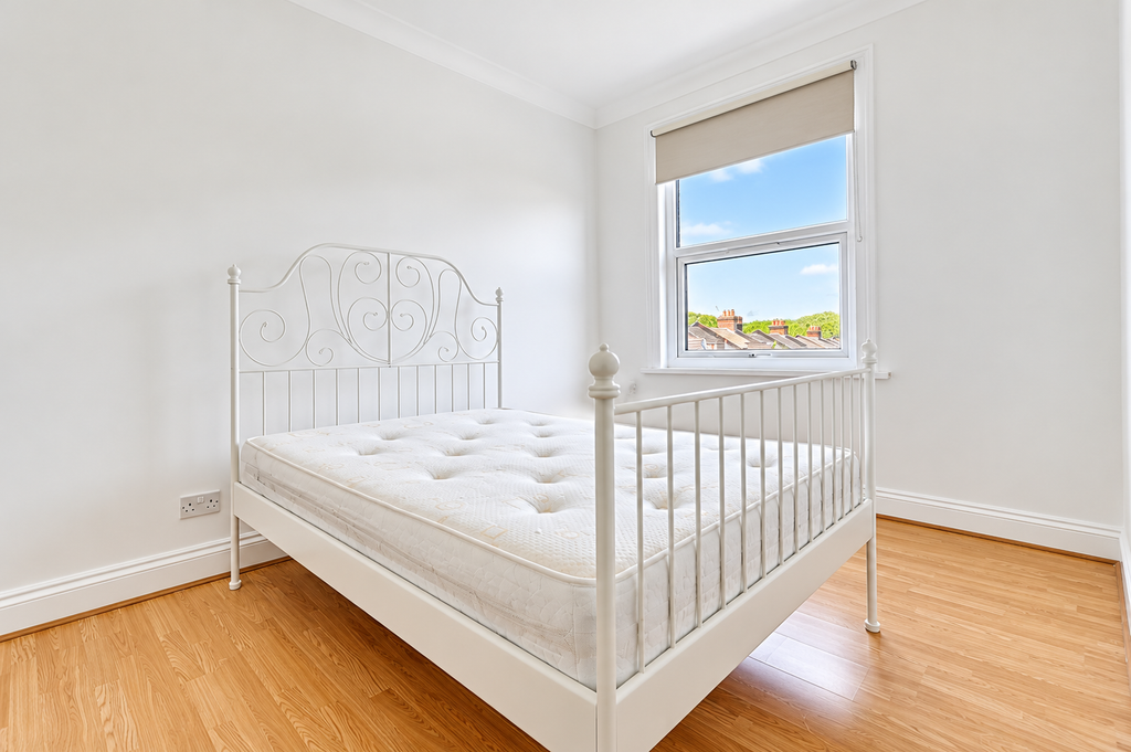 Property photo 3 of 8 Bright Minimalist Bedroom With Ornate White Bed