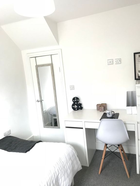 Property photo 3 of 19 This Inviting Double Bedroom Features A Cozy Bed A...