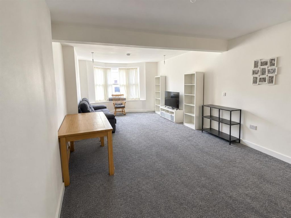 Property photo 2 of 12 Minimalist Grey-Carpeted Living Room.Jpg