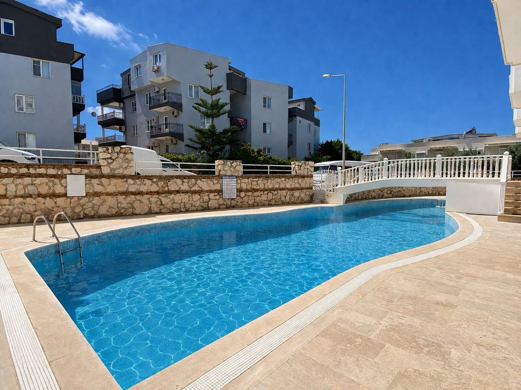 Property photo 2 of 21 Immaculate Apartment For Sale In Altinkum Â€“ Communal Pool And Sunbathing Terraces With A Feature Bridge
