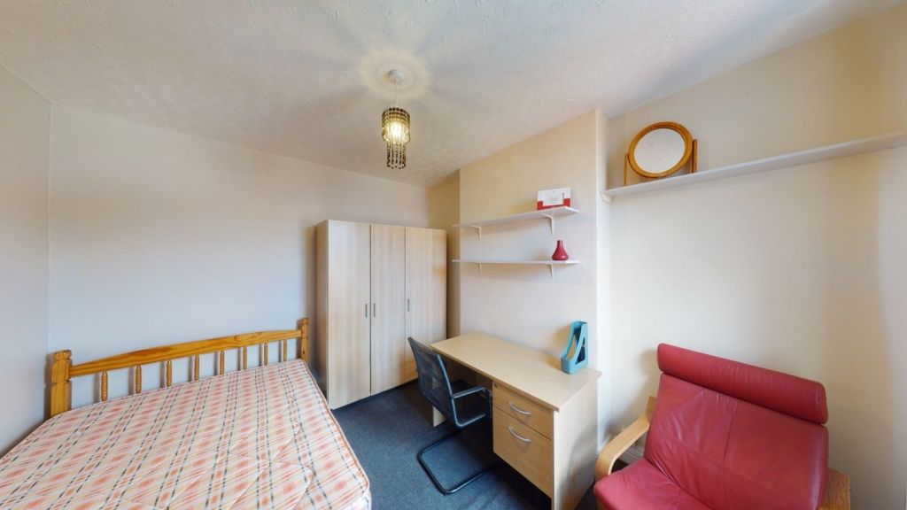 Property photo 3 of 8 Cozy Single Bedroom Featuring A Comfortable Bed, A...