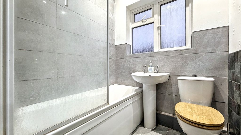 Property photo 1 of 11 Bright, Modern Bathroom With A Tiled Bath And Show...