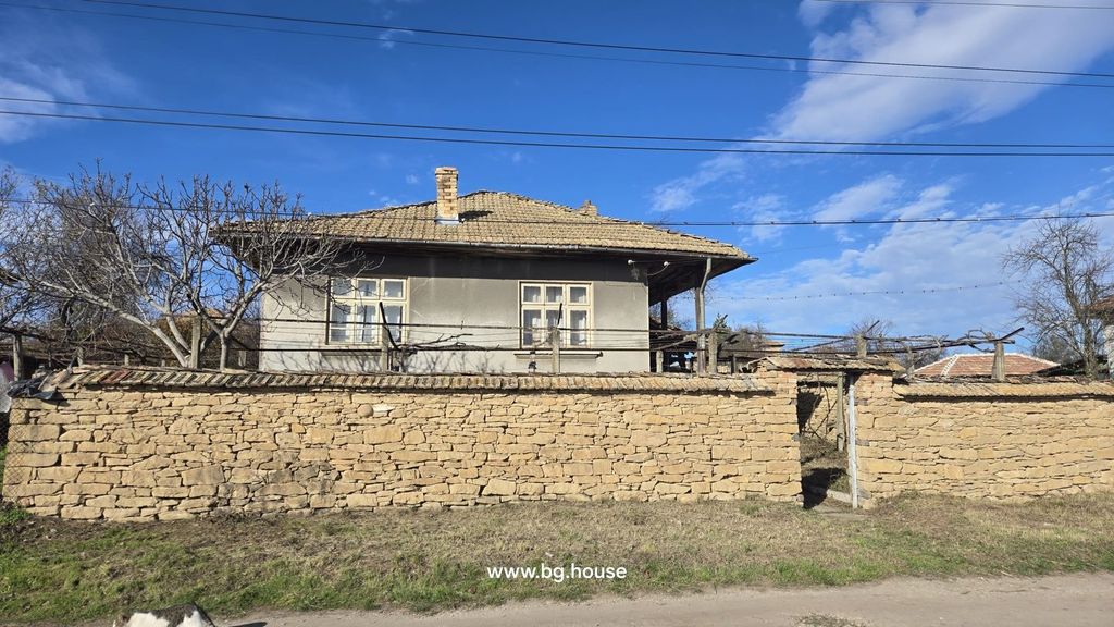 Property photo 3 of 51 Front Facade Of Bulgarian House Behind Stone Wall With Leafless Tree In Yard