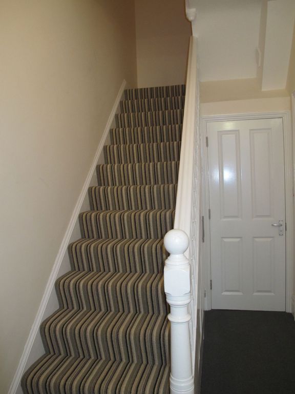 Property photo 3 of 8 Carpeted Staircase With Striped Runner, White Balu...