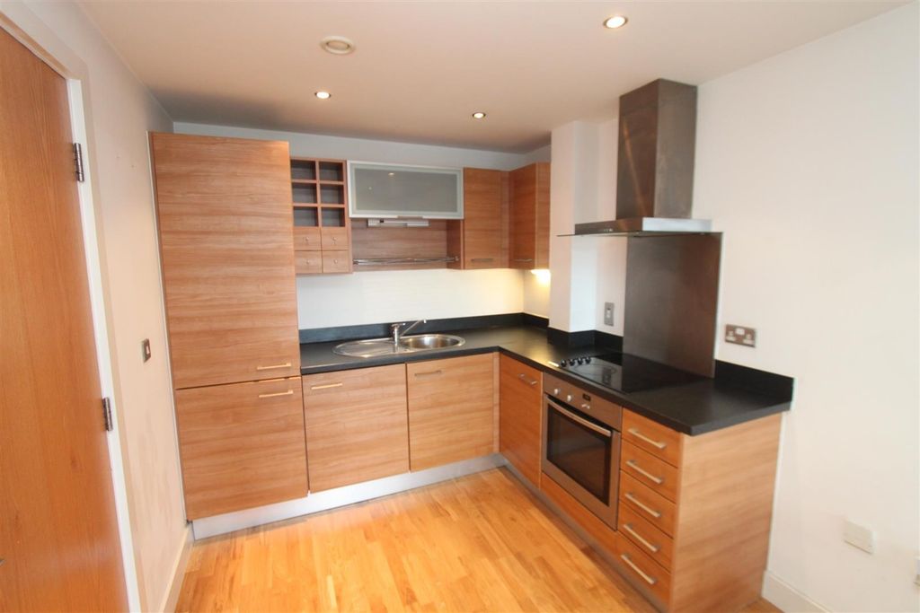 Property photo 2 of 3 Modern Kitchen With Sleek Wood-Finish Cabinetry...