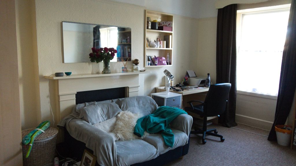 Property photo 3 of 13 A Cozy And Inviting Living Room With Ample Natural...