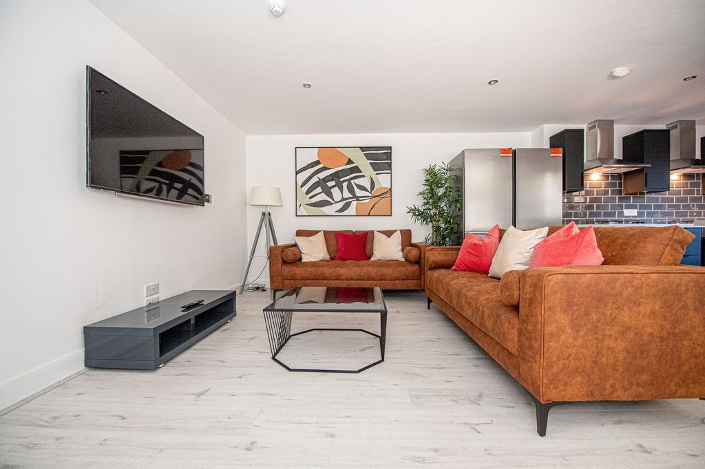 Property photo 1 of 7 Modern And Inviting Living Room Featuring Warm-Ton...