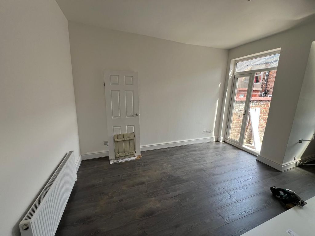 Property photo 2 of 8 A Bright Double Bedroom Featuring Dark Wood Floori...