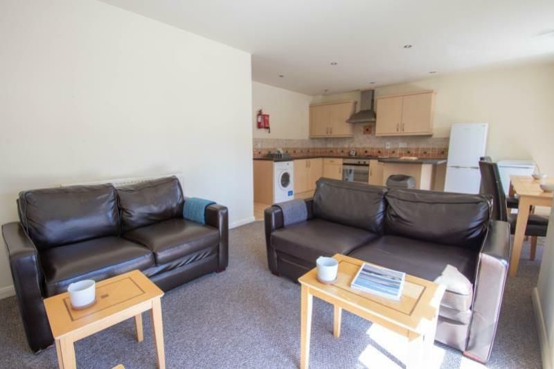 Property photo 2 of 6 A Bright And Inviting Living Room Featuring Comfor...