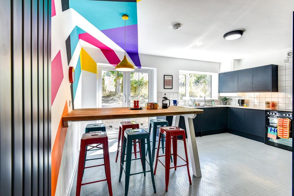 Property photo 3 of 5 A Vibrant And Modern Kitchen Featuring Colorful De...