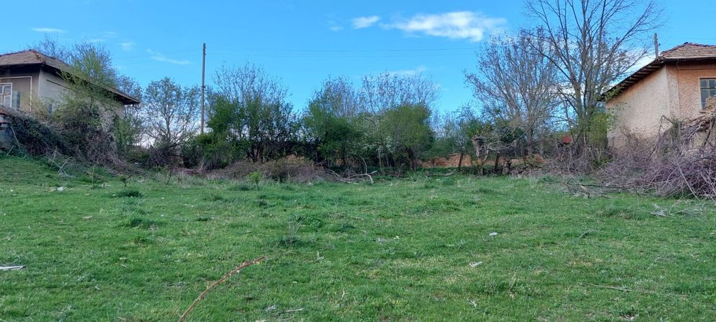 Property photo 3 of 6 An Open Grassy Area Bordered By Trees And Old Houses With Tiled Roofs On Either Side.