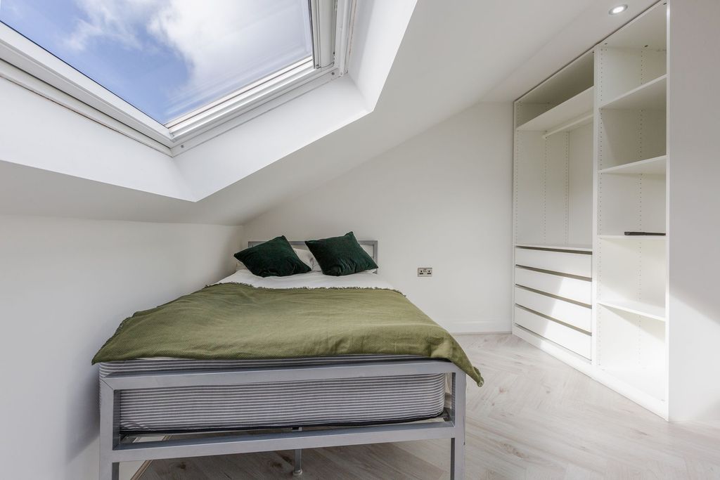 Property photo 2 of 12 A Bright, Minimalist Bedroom With A Skylight That ...