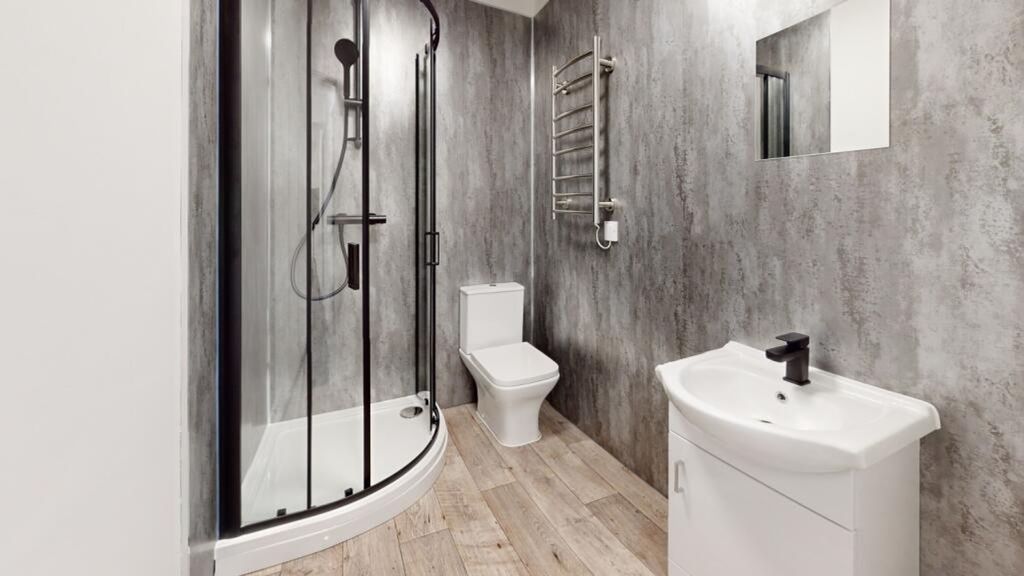 Property photo 2 of 11 A Modern And Stylish Bathroom Featuring A Sleek Sh...