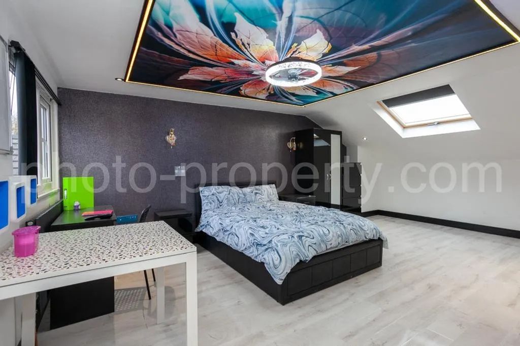 Property photo 2 of 12 This Spacious Master Bedroom Features A Stylish De...