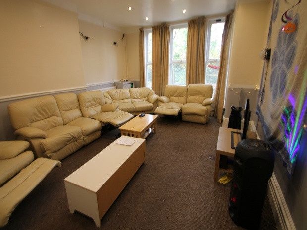 Property photo 2 of 20 A Spacious, Well-Lit Living Room Featuring Comfort...