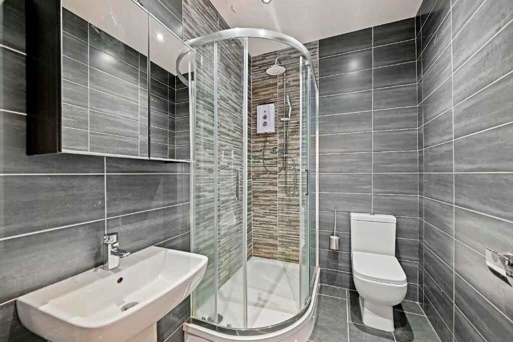Property photo 2 of 13 Modern Bathroom Suite Featuring A Sleek Glass-Encl...