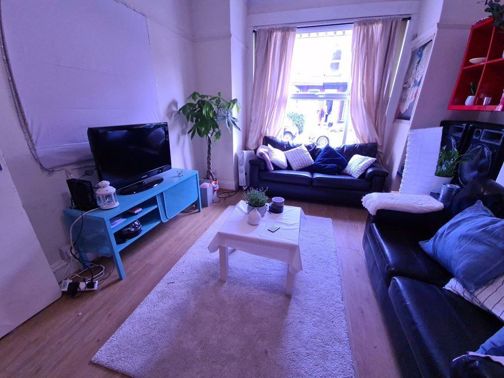 Property photo 2 of 19 Bright And Inviting Living Room Featuring A Large ...