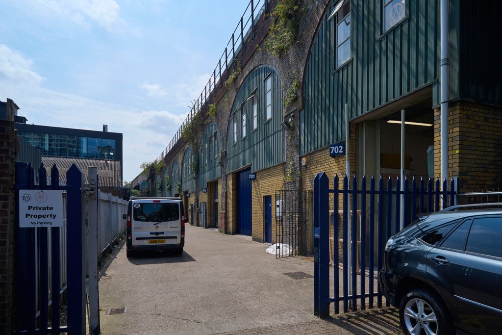 Property photo 3 of 3 An Estate, With Multiple Arches Next To Each Other. The Arches Have Closed Electric Roller Shutter Entrances.