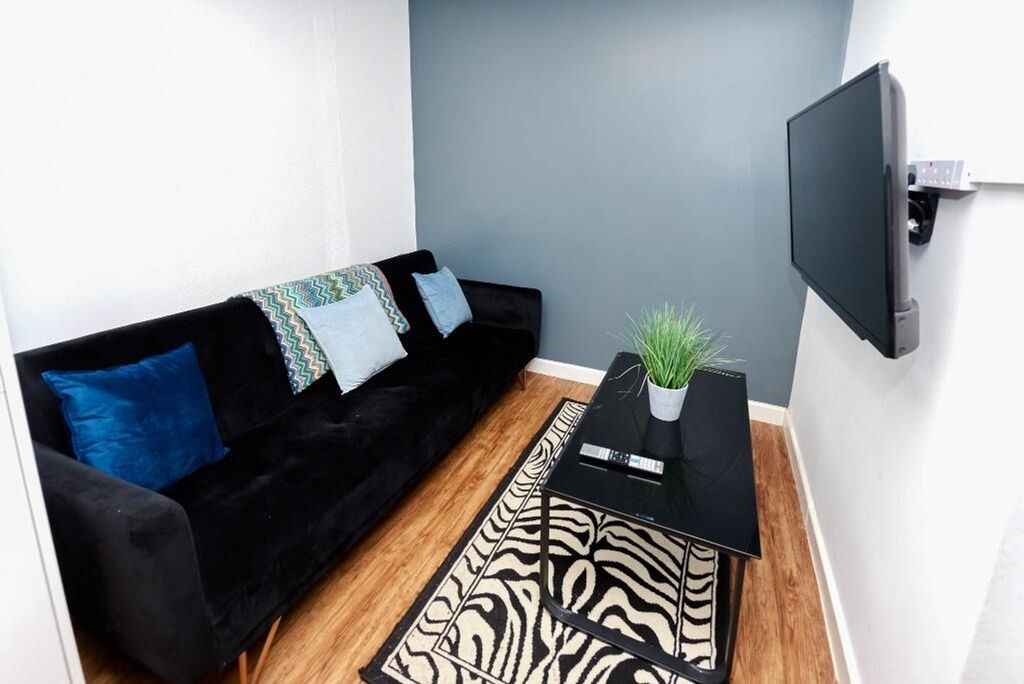 Property photo 3 of 4 A Cozy Living Room Featuring A Stylish Black Sofa ...